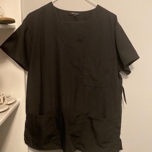 Black scrub top. Never worn. Still has tags.